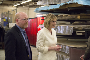Dan Berry shows Cathy Young Ulrich's unique custom sheet metal manufacturing.